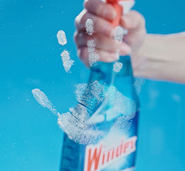 Cleaning smudges on glass with Windex